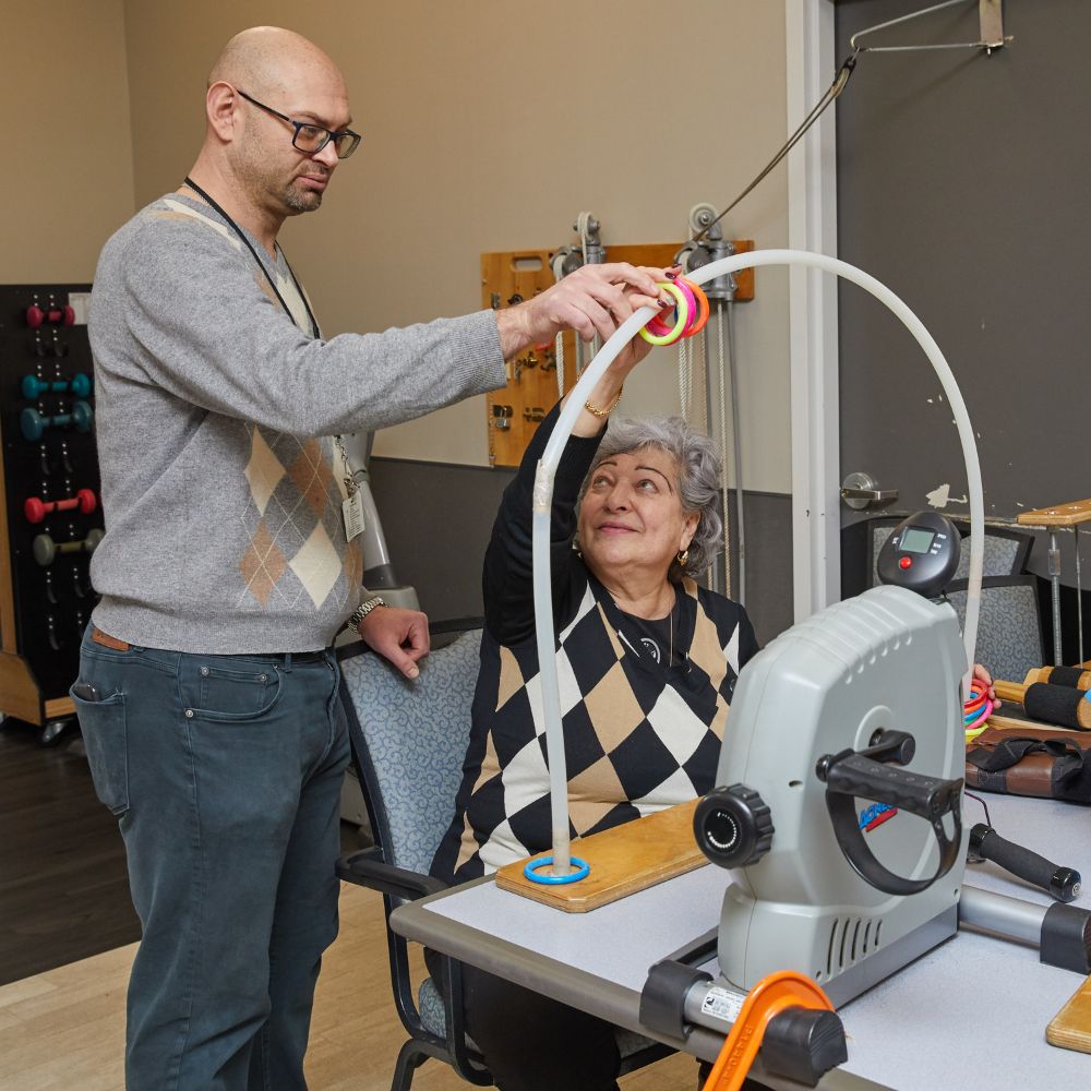 Therapist helping elderly woman with occupational therapy to recover from brain injury.