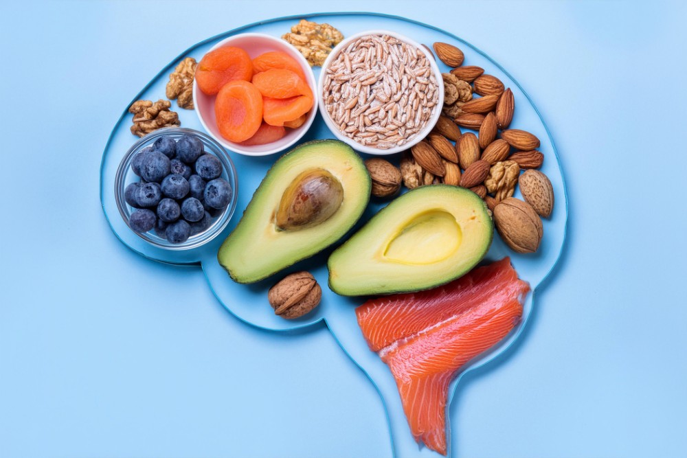 Assorted fresh fruits and nuts on a plate, highlighting their role in improving poor gut health through fiber and essential nutrients.